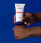Tube de crème tenu entre les mains